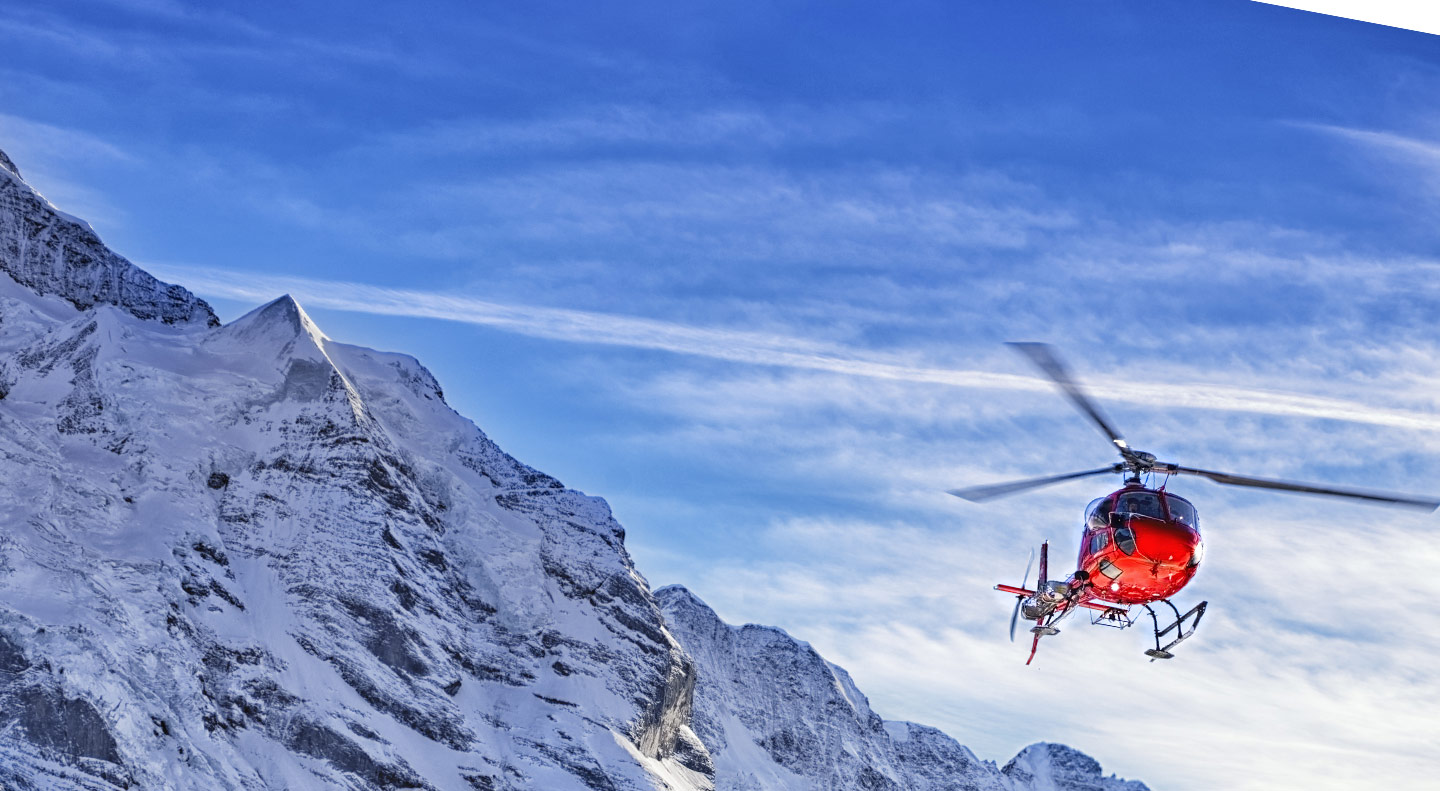 helicopter flying in mountains